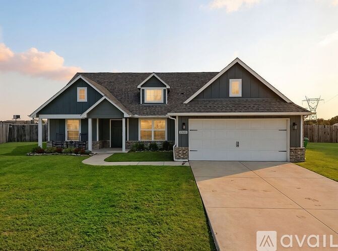 A house with a garage and a driveway is available for sale.