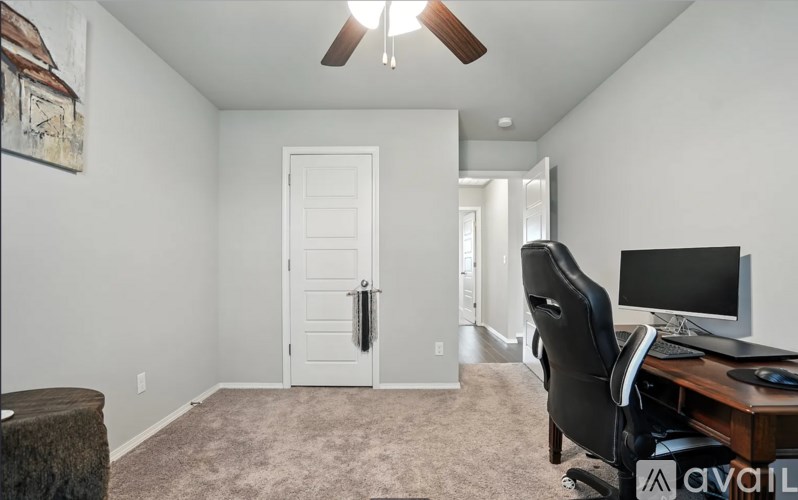A room with a desk and a computer.