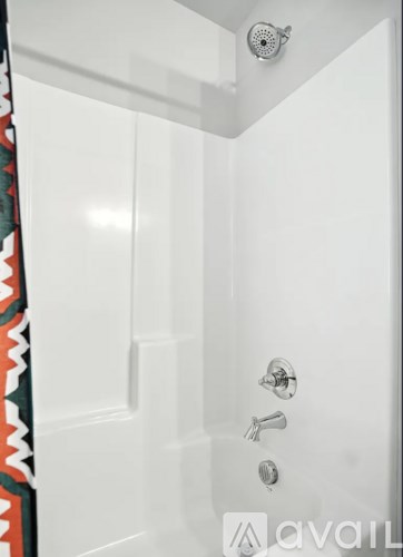 A white door with a shower head above it.