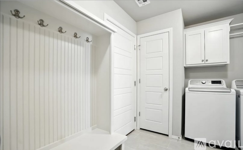 A white bathroom with a toilet, sink, and shower.