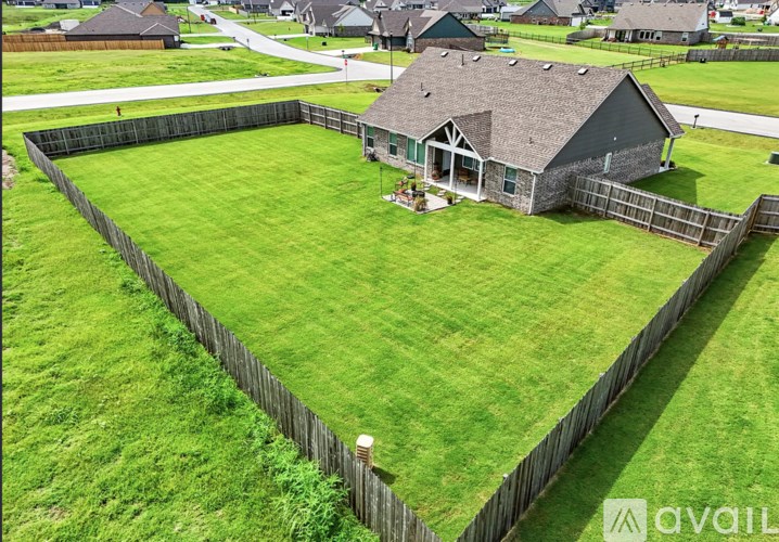 A house with a fenced yard in front of it.