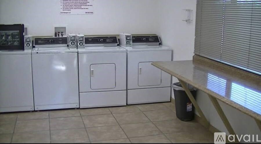 A white appliance with a black control panel is on a shelf.