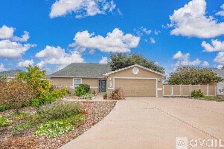 A house with a driveway and a garage is available for sale.