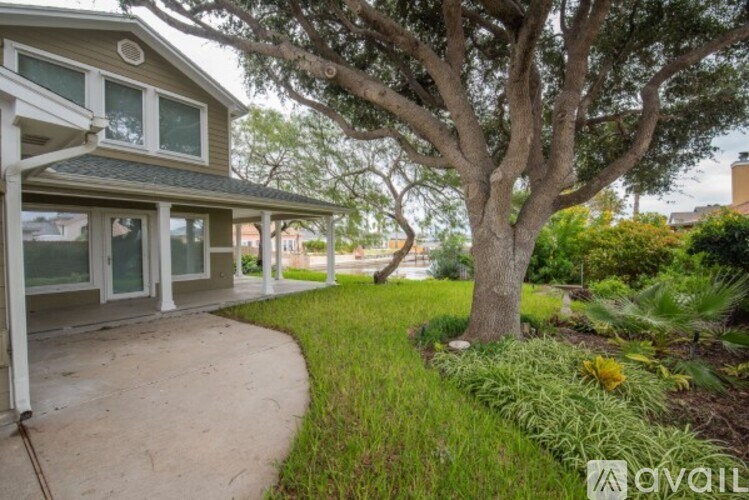 A house with a tree in front of it.