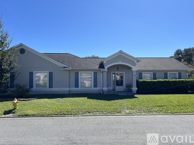 A house with a front yard and a fire hydrant.