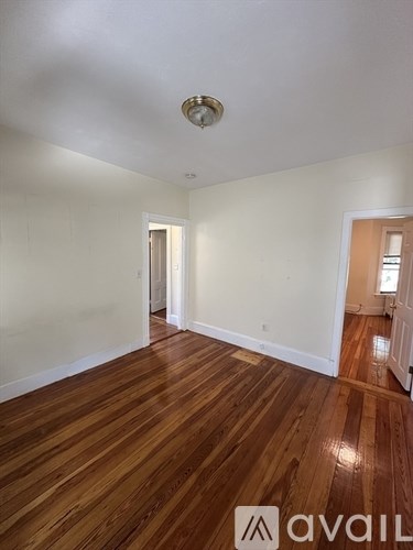 A room with wooden floors and a light on the ceiling.