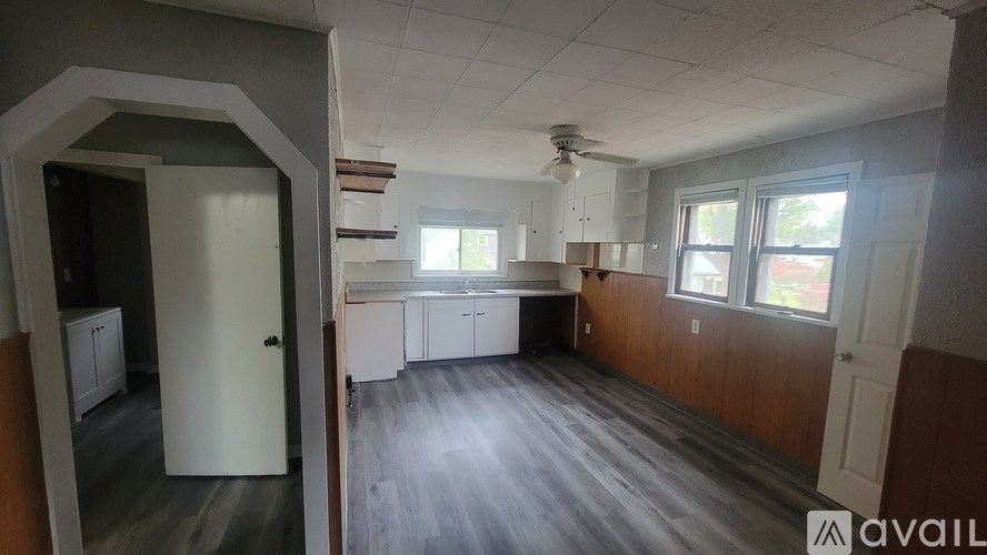 A room with wooden floors and a white door.
