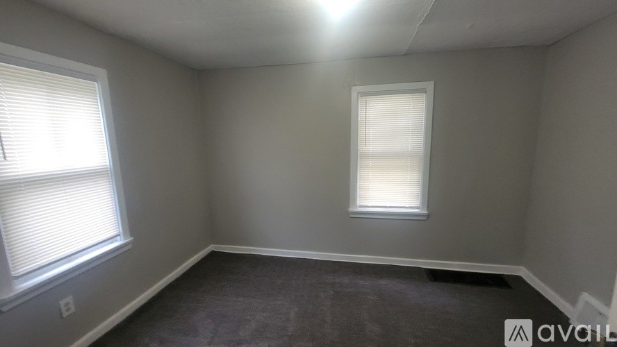 A room with a window and a smaller window on the wall.