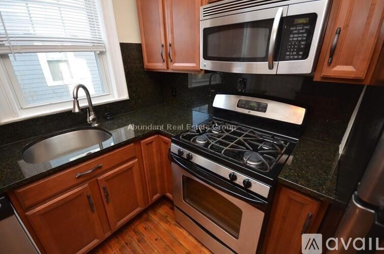 A kitchen with a stove, microwave, and oven.