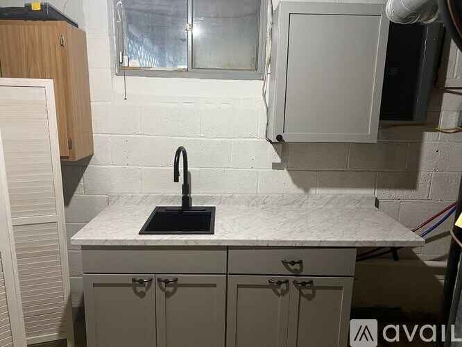 A kitchen with a sink and cabinets.