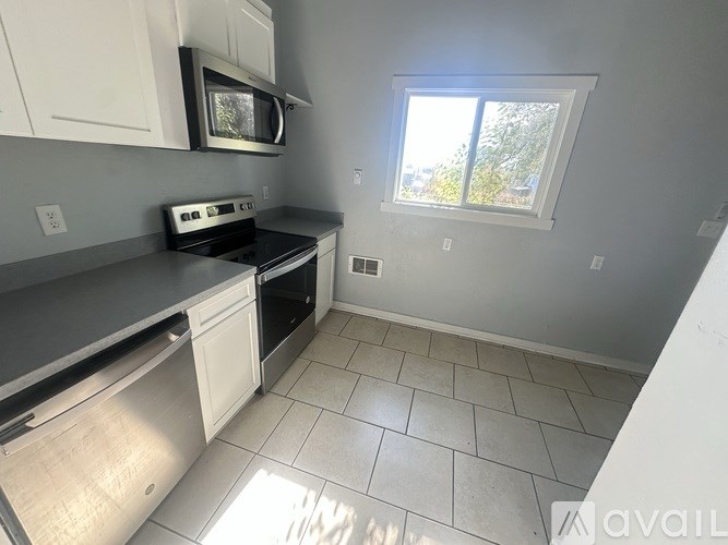 A kitchen with a microwave, oven, and dishwasher.