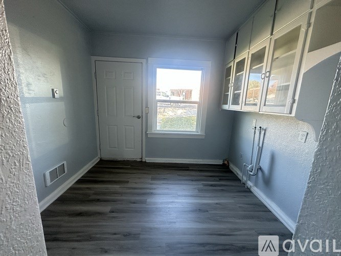 A room with wooden floors and a white door.