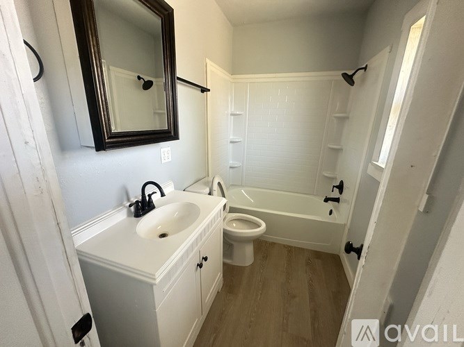 A bathroom with a sink, toilet, and bathtub.