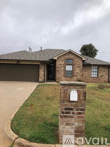 A house with a brick pillar in front of it.
