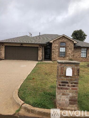 A house with a brick pillar in front of it.