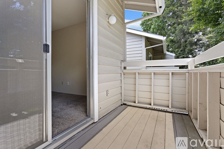 A patio area with a glass door leading to a carpeted room.