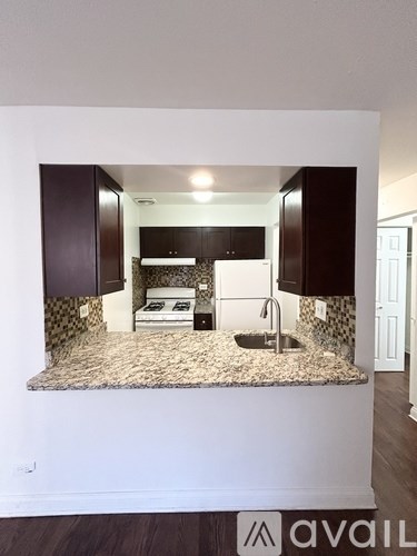 A kitchen with a granite countertop and a sink.
