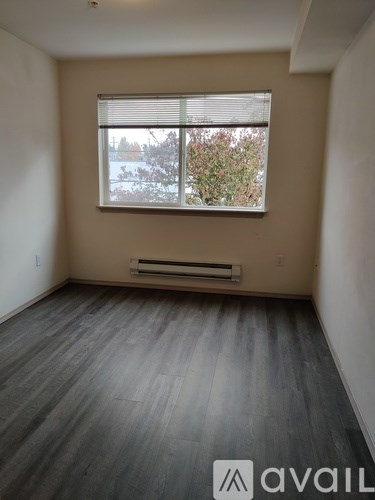 A room with a window and a bench under the window.