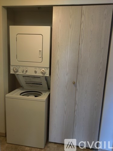 A white oven and microwave are in a cabinet.