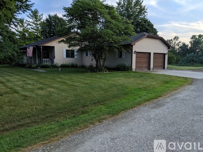 A house with a garage and a flag on the front porch.