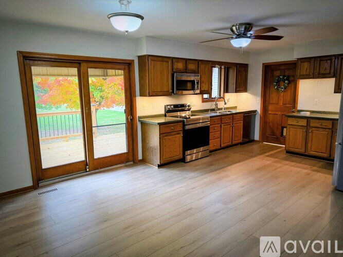 A kitchen with wooden cabinets and a wreath on the door.