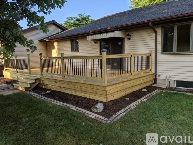 A house with a wooden deck and a small garden.