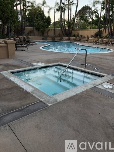 A pool with a waterfall in the middle of it.