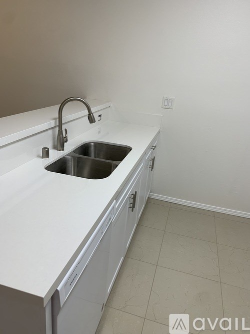 A white kitchen sink with a silver faucet.