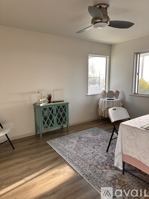 A room with a bed, a chair, and a cabinet.