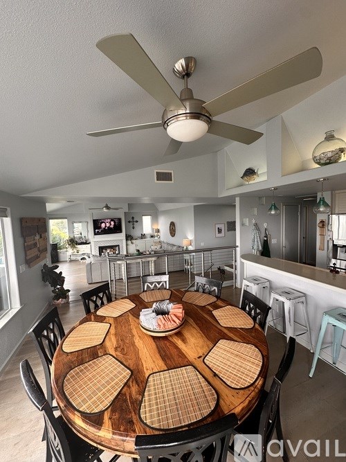 A dining room with a wooden table and chairs.