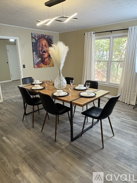 A dining room with a wooden table and chairs.