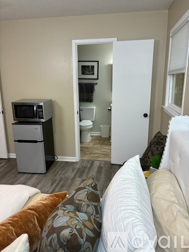 A living room with a couch and a microwave.