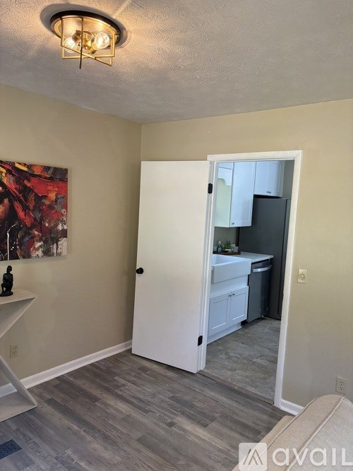 A kitchen area with a white door leading to another room.