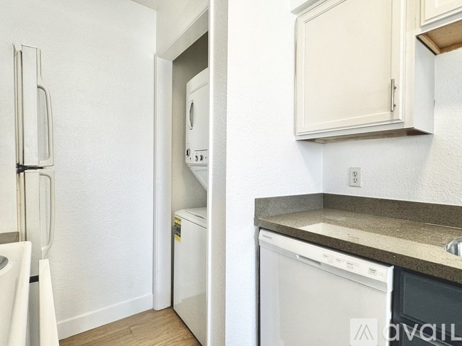 A white fridge and a white dishwasher in a kitchen.