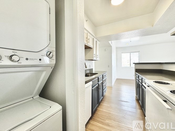 A white oven is in a kitchen with wooden floors.