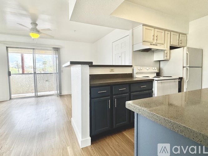 A kitchen with a blue island and wooden cabinets.