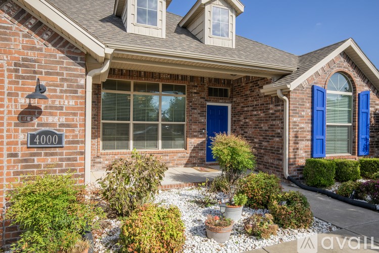 A house with blue shutters and a brick facade.