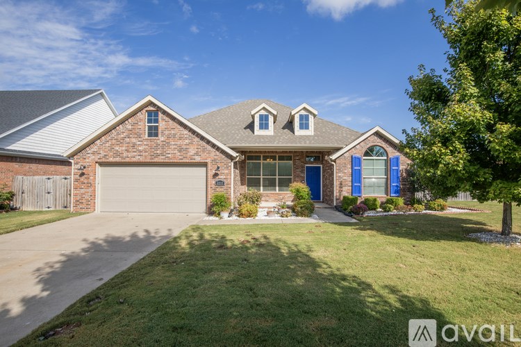 A house with a blue garage door is for sale.