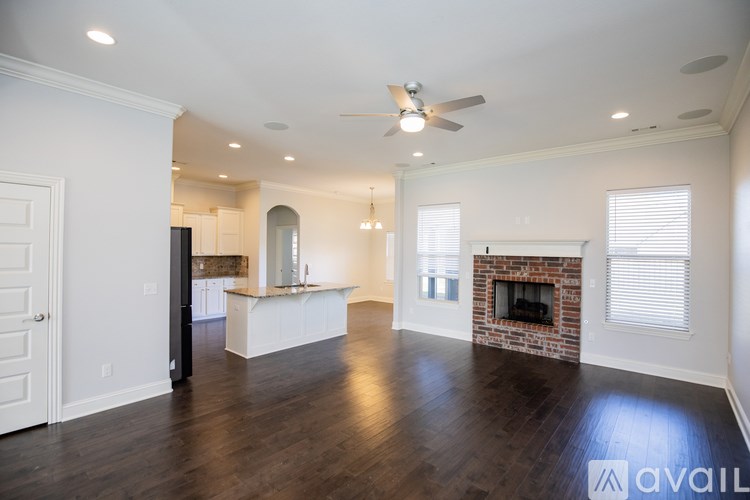 A spacious living room with a fireplace and a television.