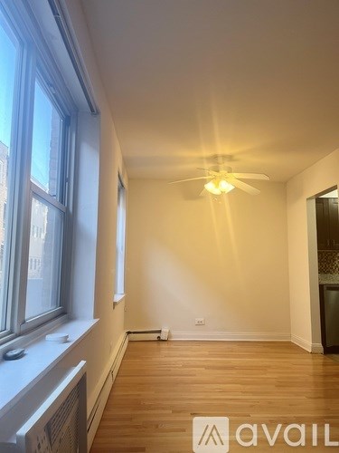 A room with wooden floors and a ceiling fan.