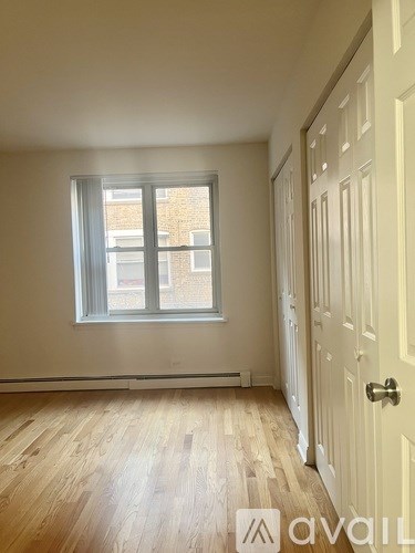 A room with a wooden floor and a white door.