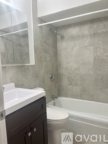 A bathroom with a toilet, sink, and bathtub.