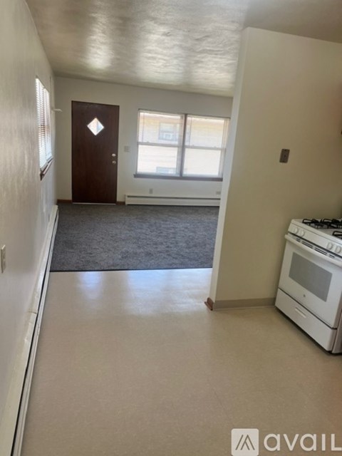 A kitchen with a stove and a door.