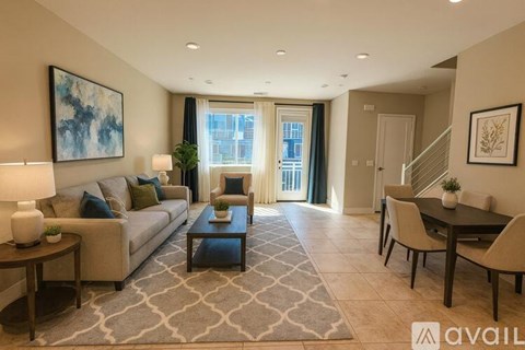 A living room with a couch, coffee table, and a painting on the wall.