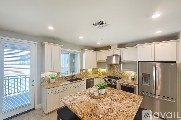 A kitchen with granite countertops and stainless steel appliances.