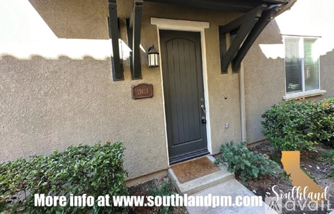 A house with a black door and a number 1413 on the wall.