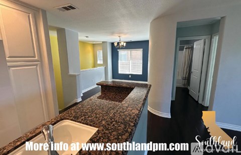 A kitchen with granite countertops and a sink.