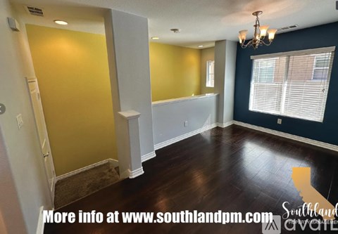 A room with yellow and blue walls and a white door.