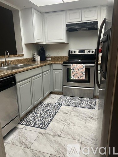 A kitchen with a stove top oven and a refrigerator.