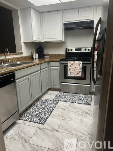 A kitchen with a stove top oven and a refrigerator.